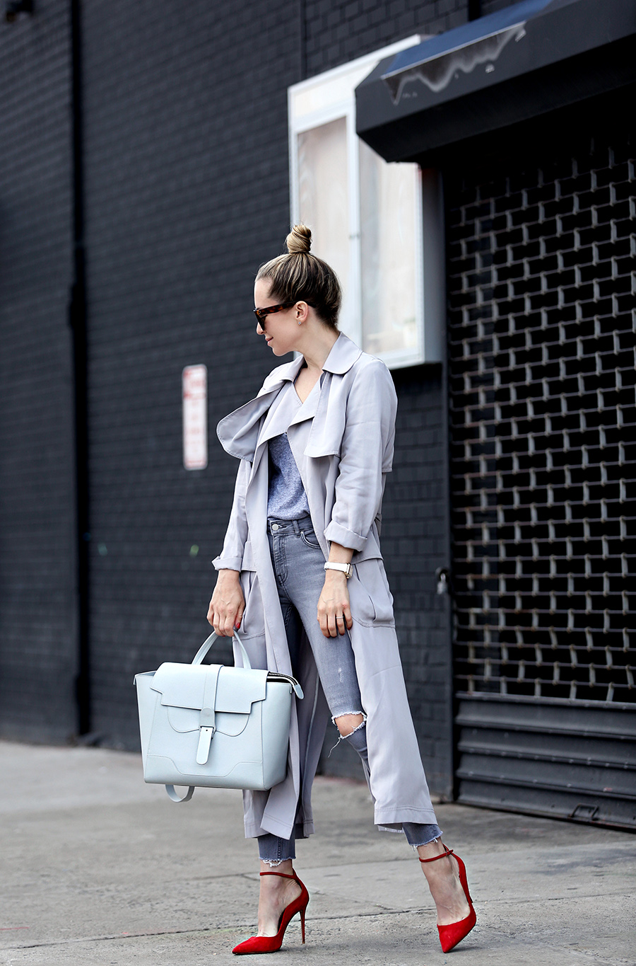 Helena of Brooklyn Blonde wearing a grey monochromatic outfit with Topshop long grey duster jacket, red Aquazzura heels, Senreve bag, MONROW tee, MICHELE watch