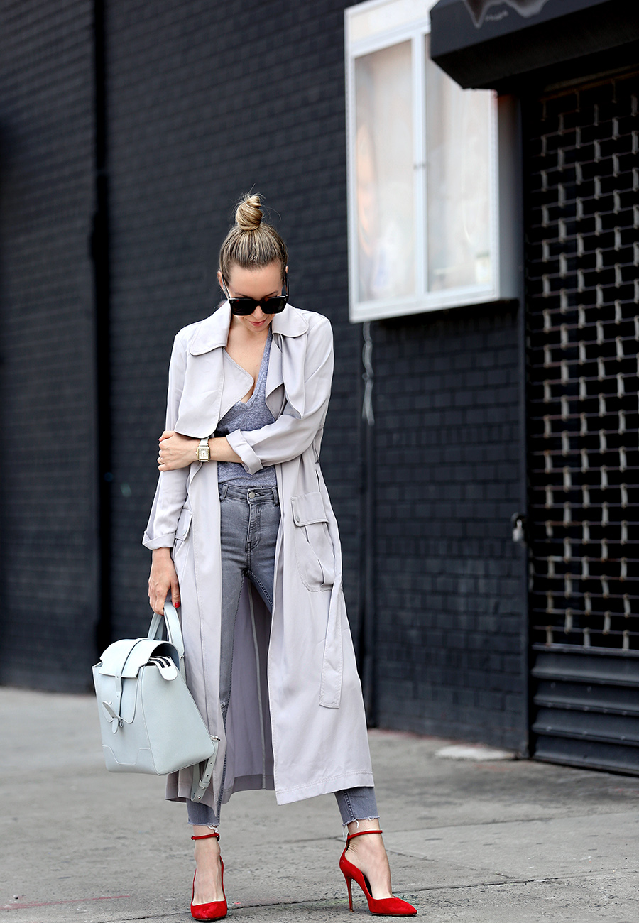Helena of Brooklyn Blonde wearing a grey monochromatic outfit with Topshop long grey duster jacket, red Aquazzura heels, Senreve bag, MONROW tee, MICHELE watch