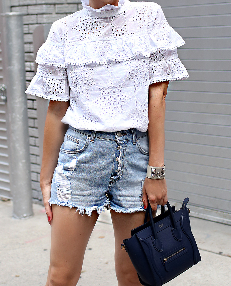 Helena Glazer of Brooklyn Blonde wearing J.O.A. white eyelet ruffled top, Zara distressed denim shorts, Aquazzura lace up flats, Hermes cuff