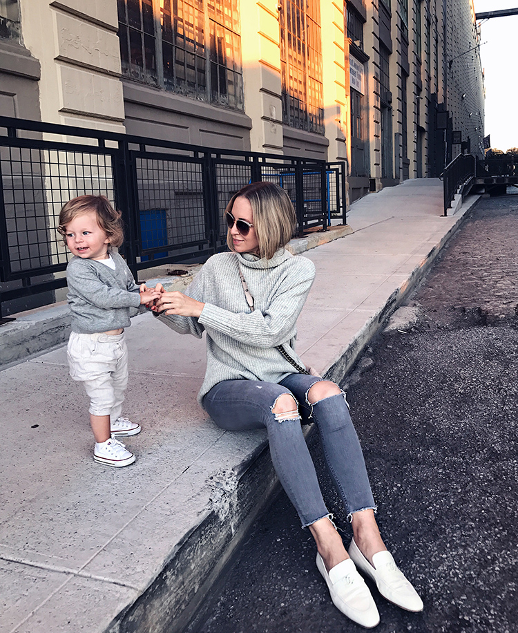Helena Glazer with her child sitting near the street