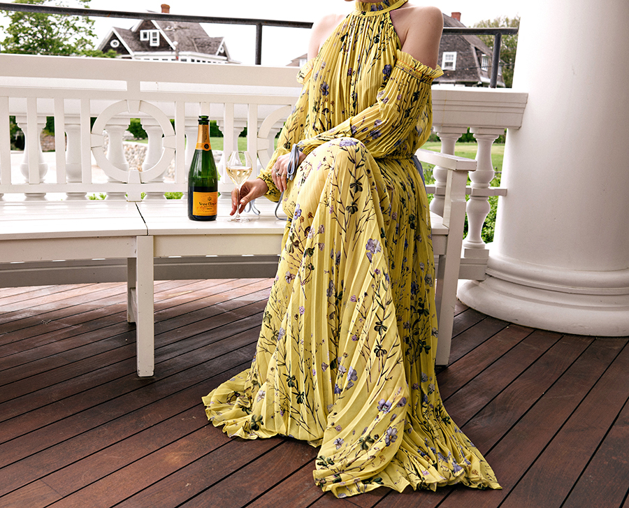 Helena of Brooklyn Blonde drinking Veuve Clicquot Summer Beverage, wearing yellow dress, and sharing the secret to happiness 