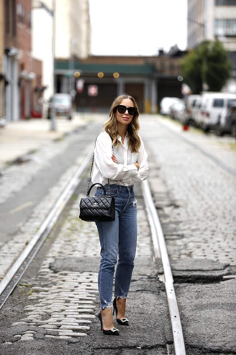 woman in the middle of the street wearing Sheer White Button Down & Blue Denim