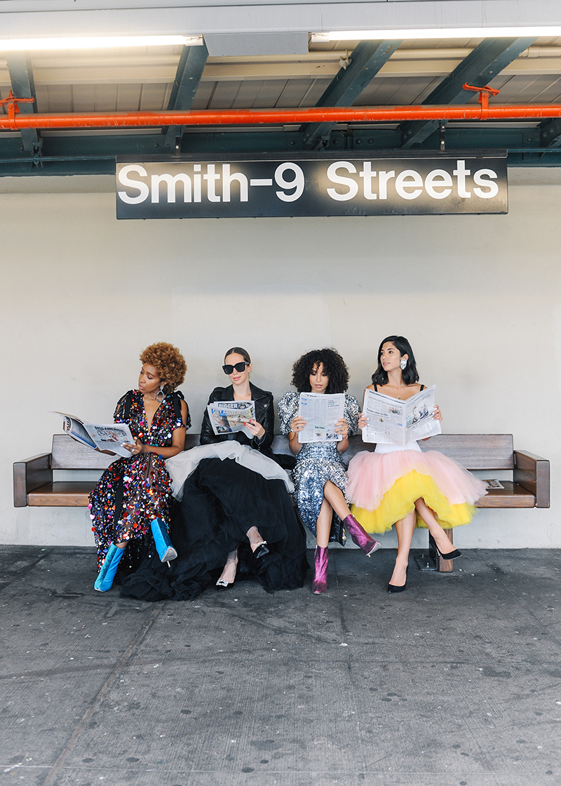 four women sitting and sharing Who Runs The World