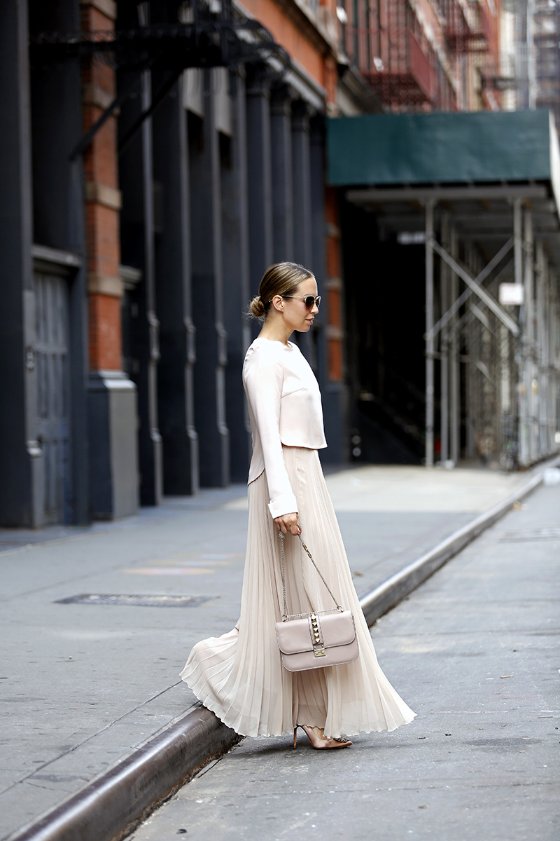 woman wearing Monochromatic Blushing Outfit from Zara Pleated Maxi Skirt, All Saints Blush Leather Jacket, Helena of Brooklyn Blonde