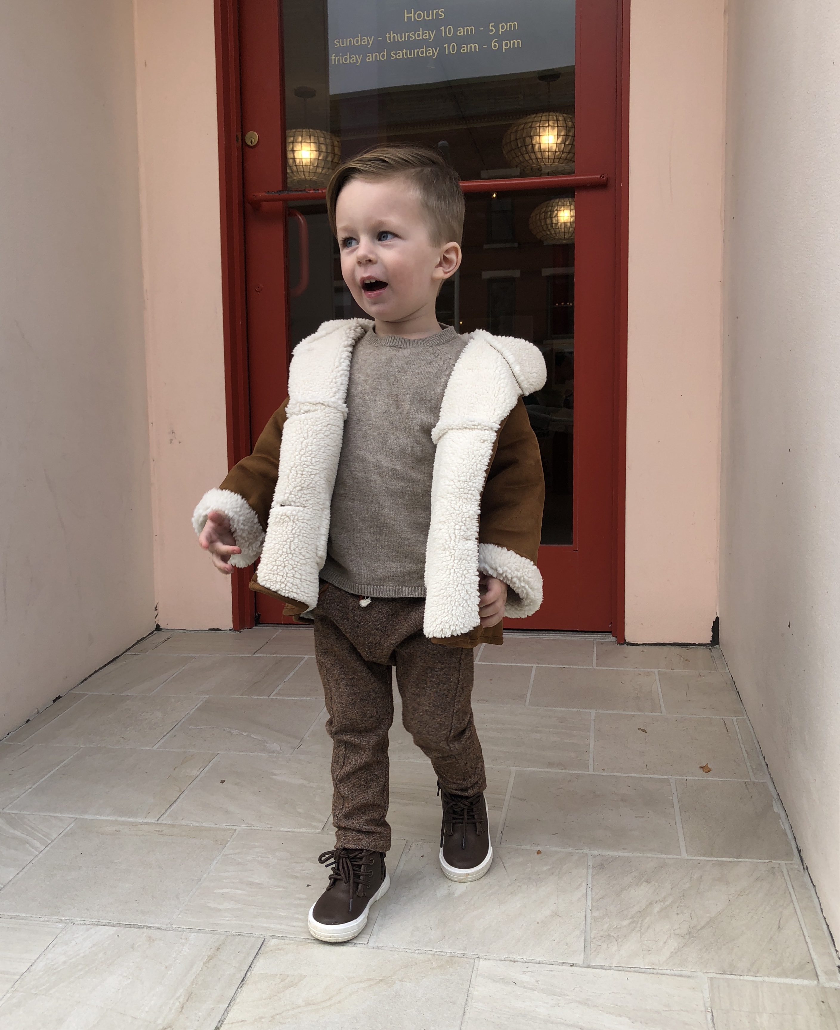 kid outside a store for a happy friday