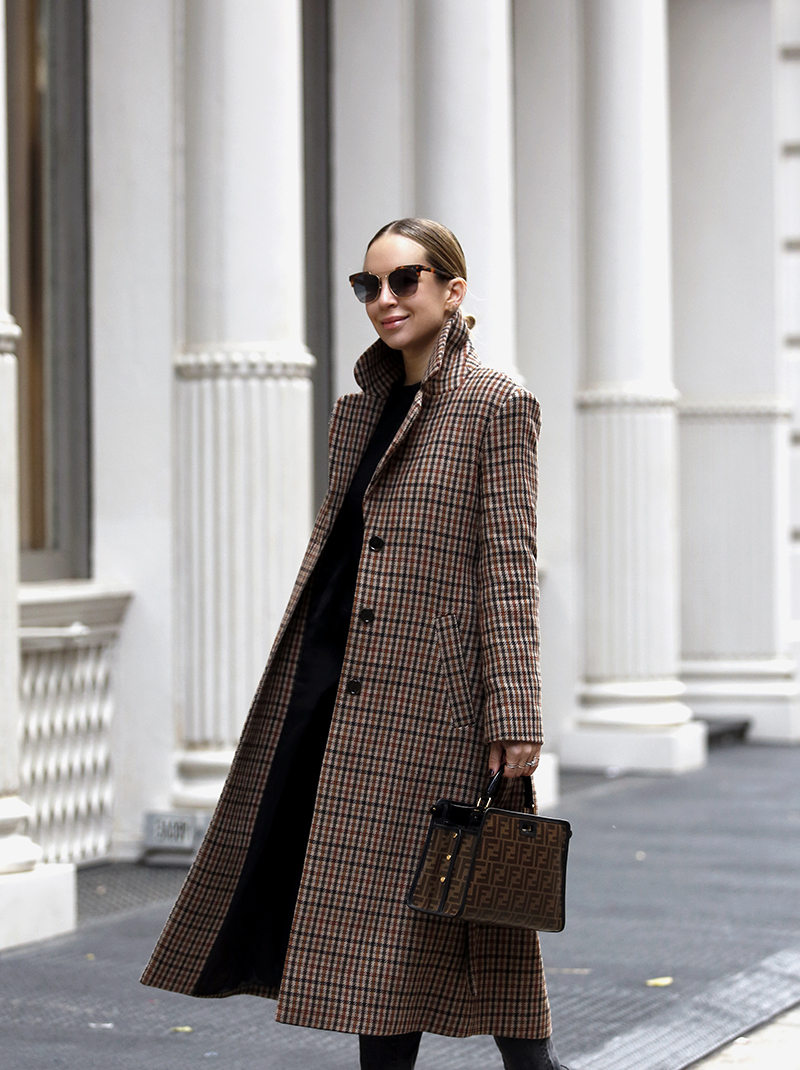 woman smiling and wearing her Favorite Plaid Coat and in all black top and jeans 