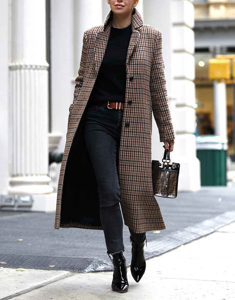 woman wearing her Favorite Plaid Coat and in all black top and jeans 