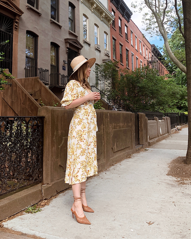 Weekend Links - Helena is wearing a yellow floral midi dress.