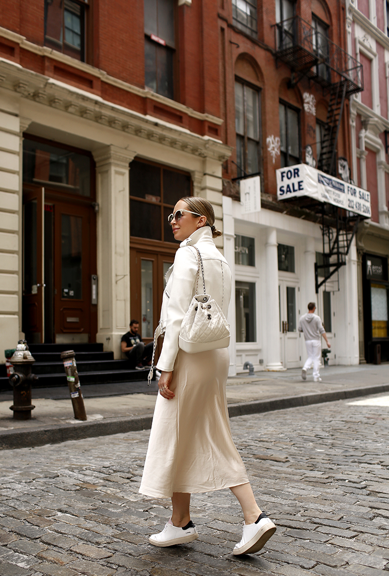 White Leather Biker Jacket, Beige Slip Dress, Axel Arigato White Sneakers, Chanel White Quilted Backpack, Spring Summer Maternity Outfit Idea, Helena of Brooklyn Blonde