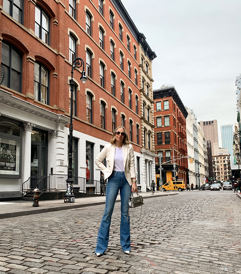 Brooklyn Blonde Blogger Helena Glazer wearing Flared Denim, white shirt, and blazer and standing on the street