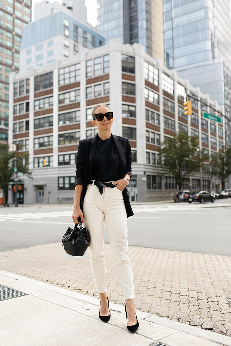 woman in the streets wearing black top, white jeans, and her Favorite Pairs of Sunglasses