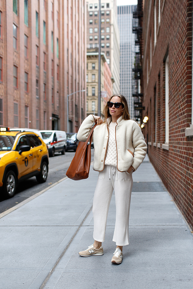 woman standing at the side of the street 