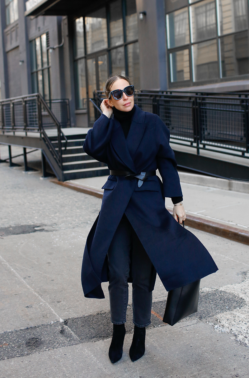 woman wearing blue trench coat from holiday sales worth noting