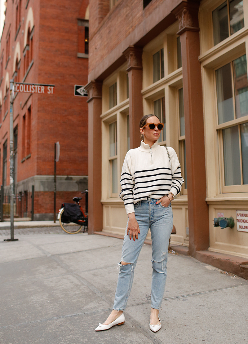 woman wearing her favorite Pairs of Denim, a sweater, and white flats