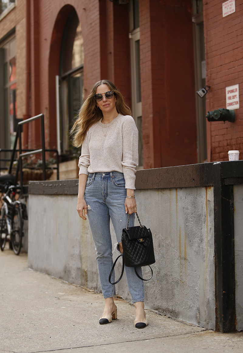 woman wearing jeans, sweater, and her favorite pair of sunglasses