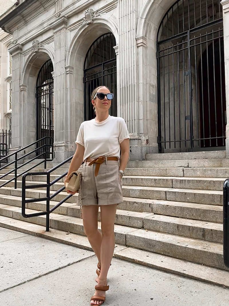 woman standing and wearing tshirt and shorts