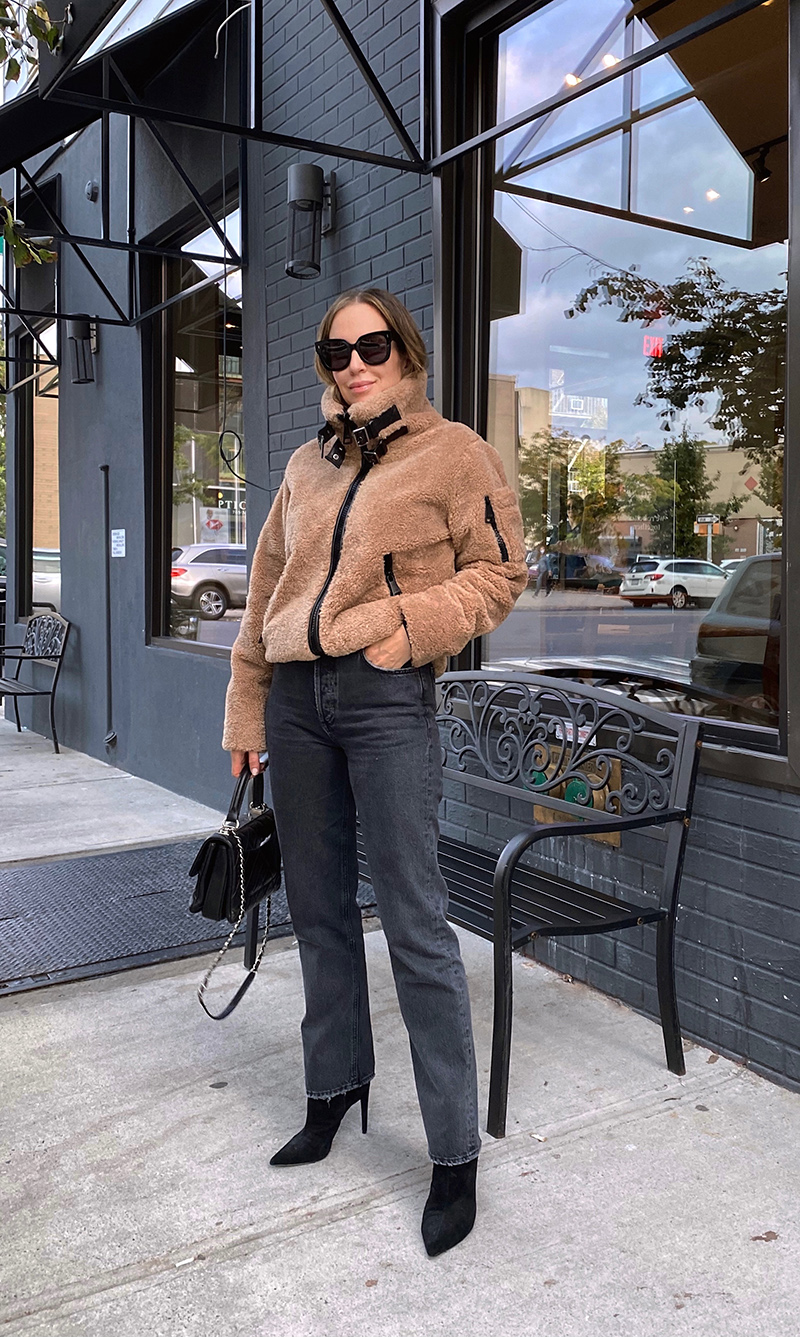 woman wearing brown jacket and black jeans for denim roundup 