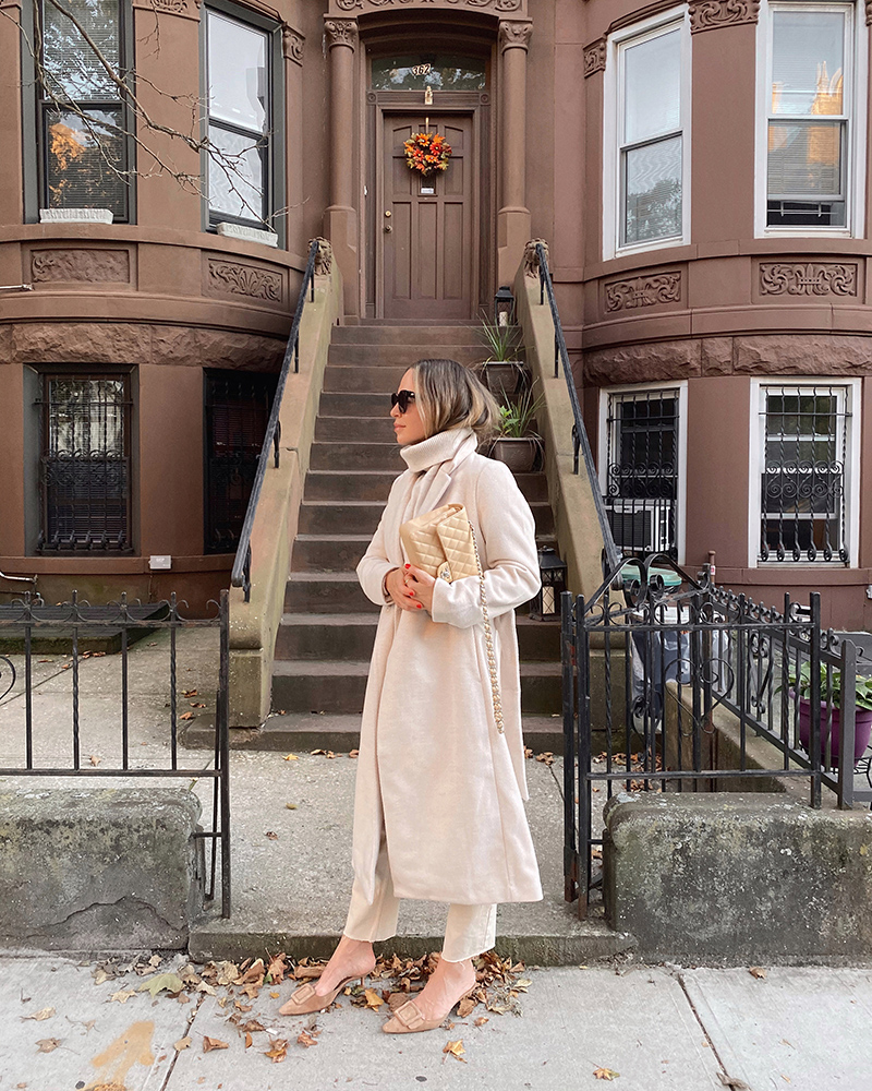 woman wearing long coat with beige bag for Past Fall Favorites