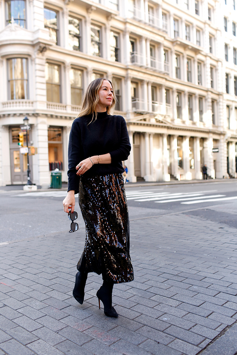 woman wearing All Black & Sequins skirt and walking on the street 