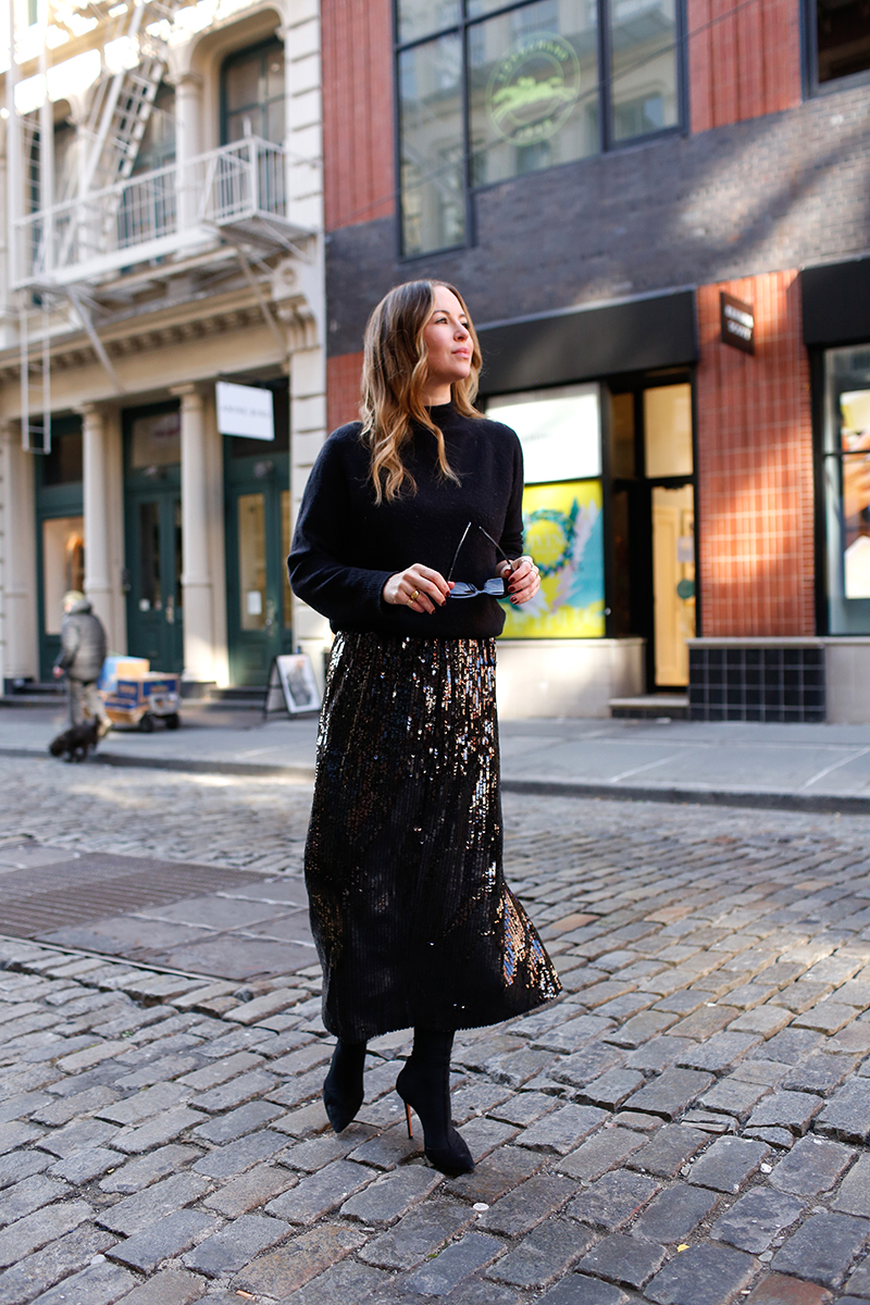 woman in all black skirt and sweater