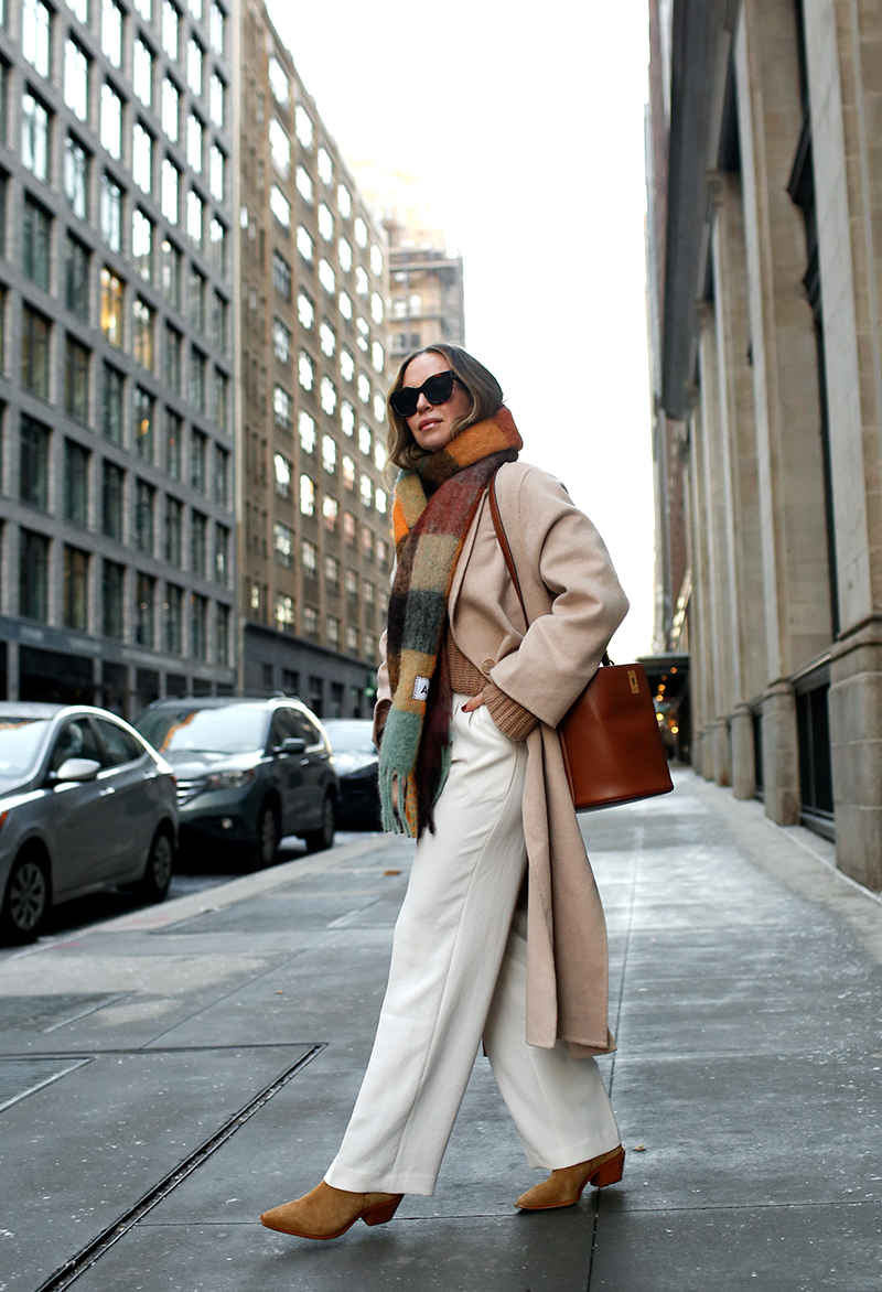 woman sharing Winter Wear with plaid scarf and white pants 