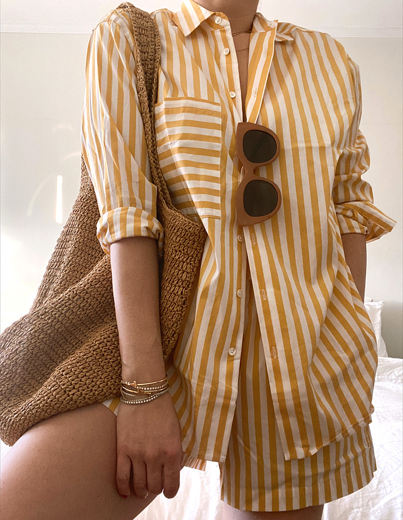 woman wearing Vacation Edition striped yellow button down 