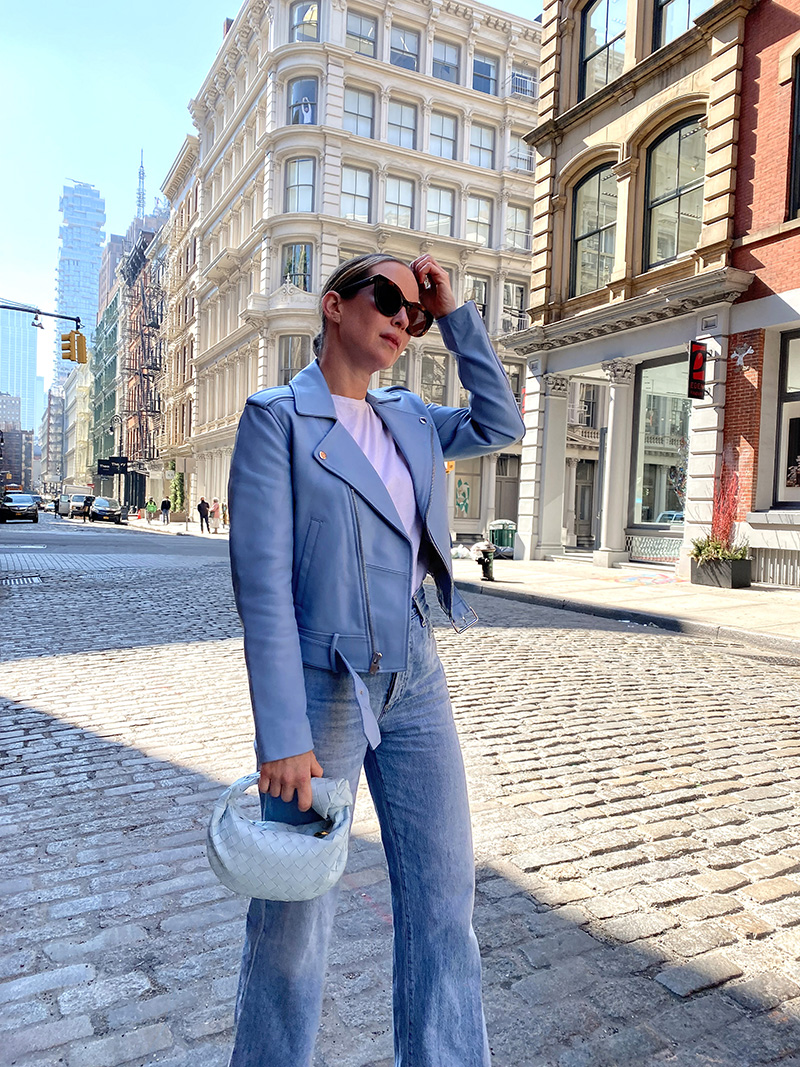 woman wearing jeans and jacket in Shades of Blue and holding a bag