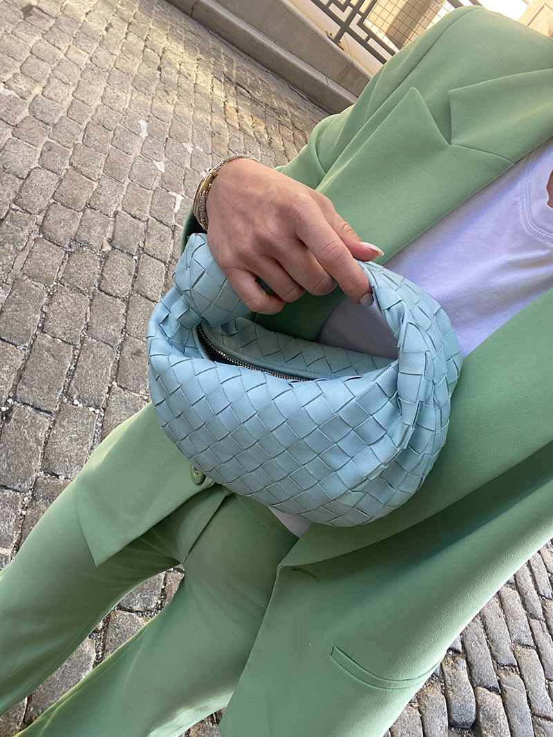 woman on the streets wearing Mint Chip inspired outfit and a bag