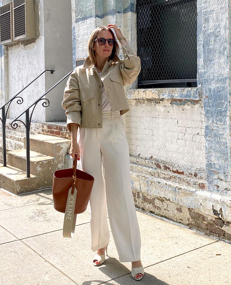 woman holding the The Celine Bucket 16 in brown