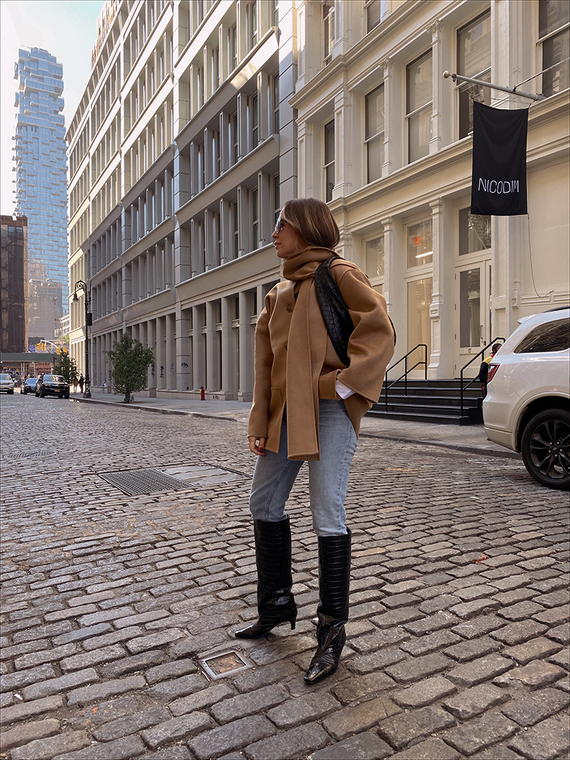 woman showing one of her Seven Recent Outfits where she wears jeans, boots, a coat, and scarf