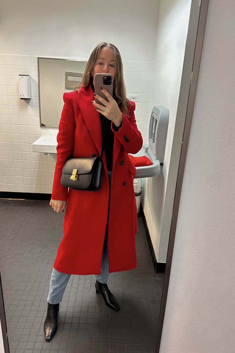 woman showing one of her Seven Recent Outfits where she wears jeans, boots, a red coat, and a bag