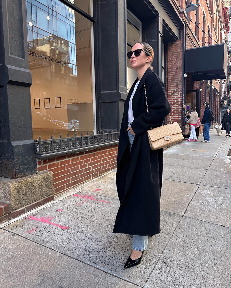 woman wearing Prada Moddellerie Mary Jane Pumps, white shirt, and black coat