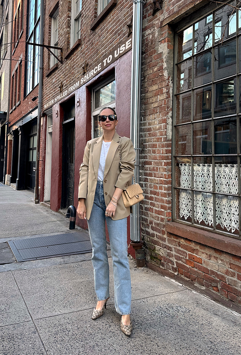 woman wearing Gucci Aria Slingbacks, jeans, and oversized jacket