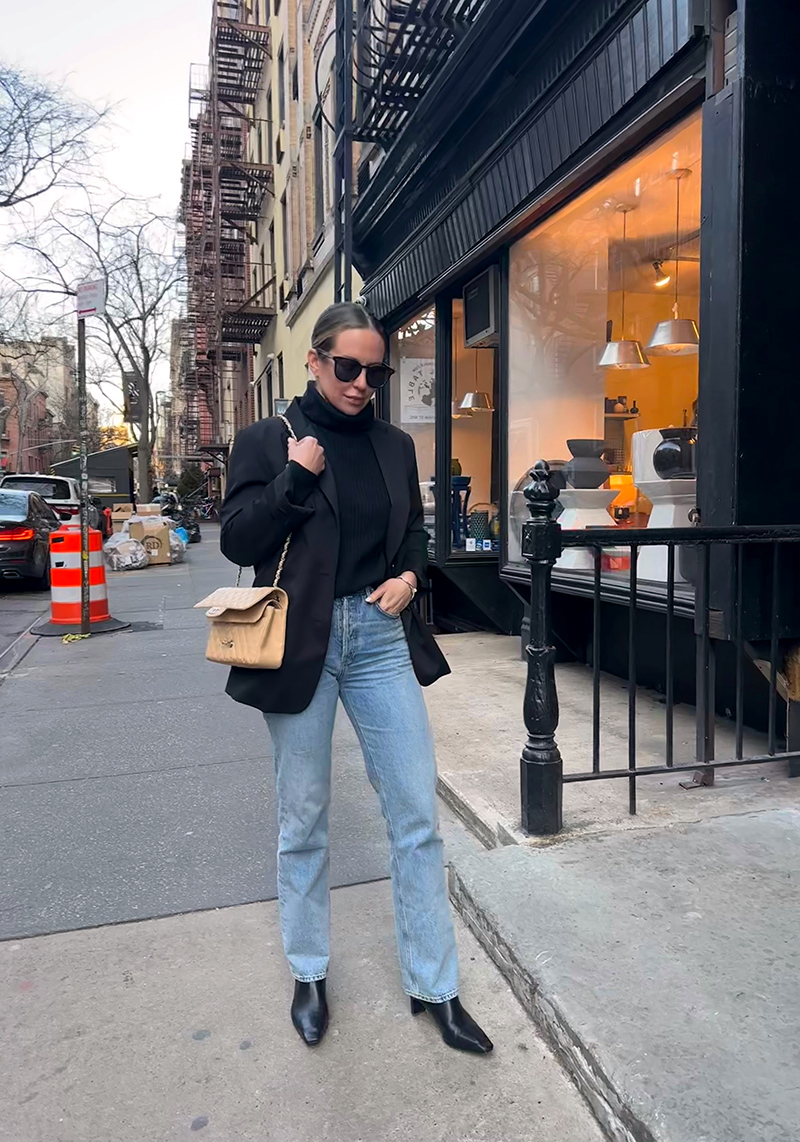 woman wearing oversized blazer, turtle neck, jeans, and boots