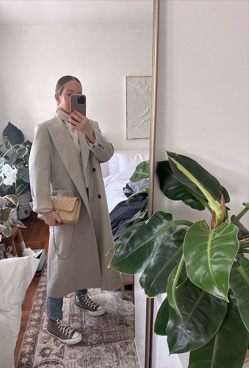woman wearing trench coat, turtle neck sweater, and sneakers for Week In Outfits